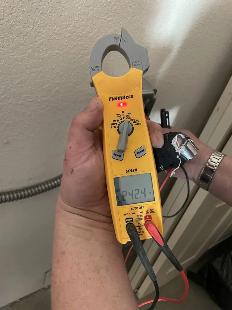 Voltage testing with clamp meter during Whole House Surge Protector in Dexter
